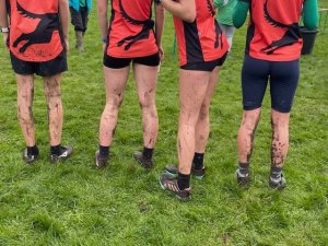 Four Juniors showing the back of their muddy legs