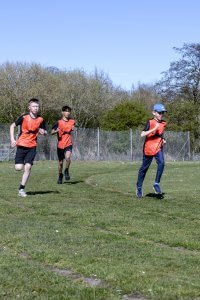 Juniors doing running, jumping and throwing.