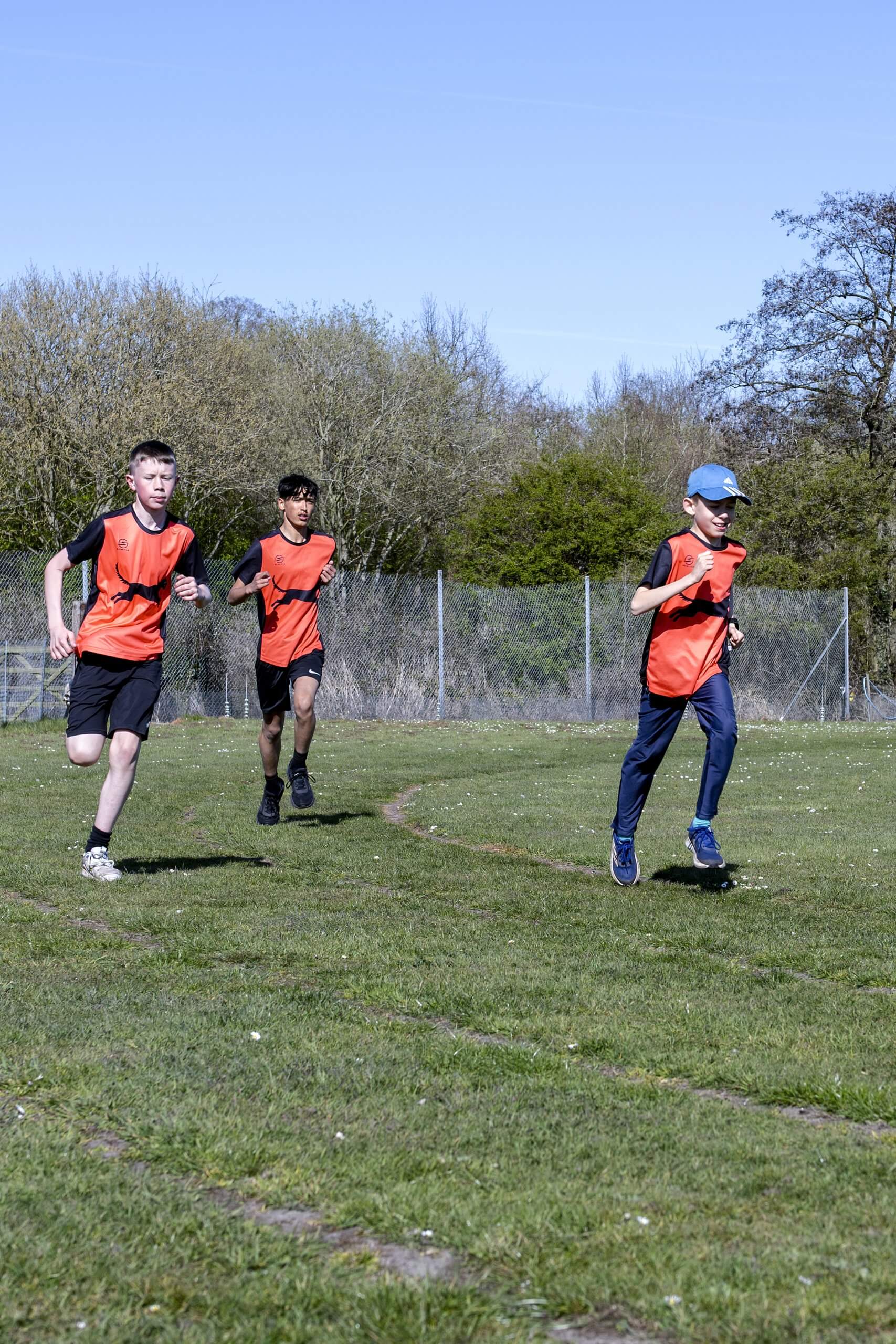 Juniors doing running, jumping and throwing.