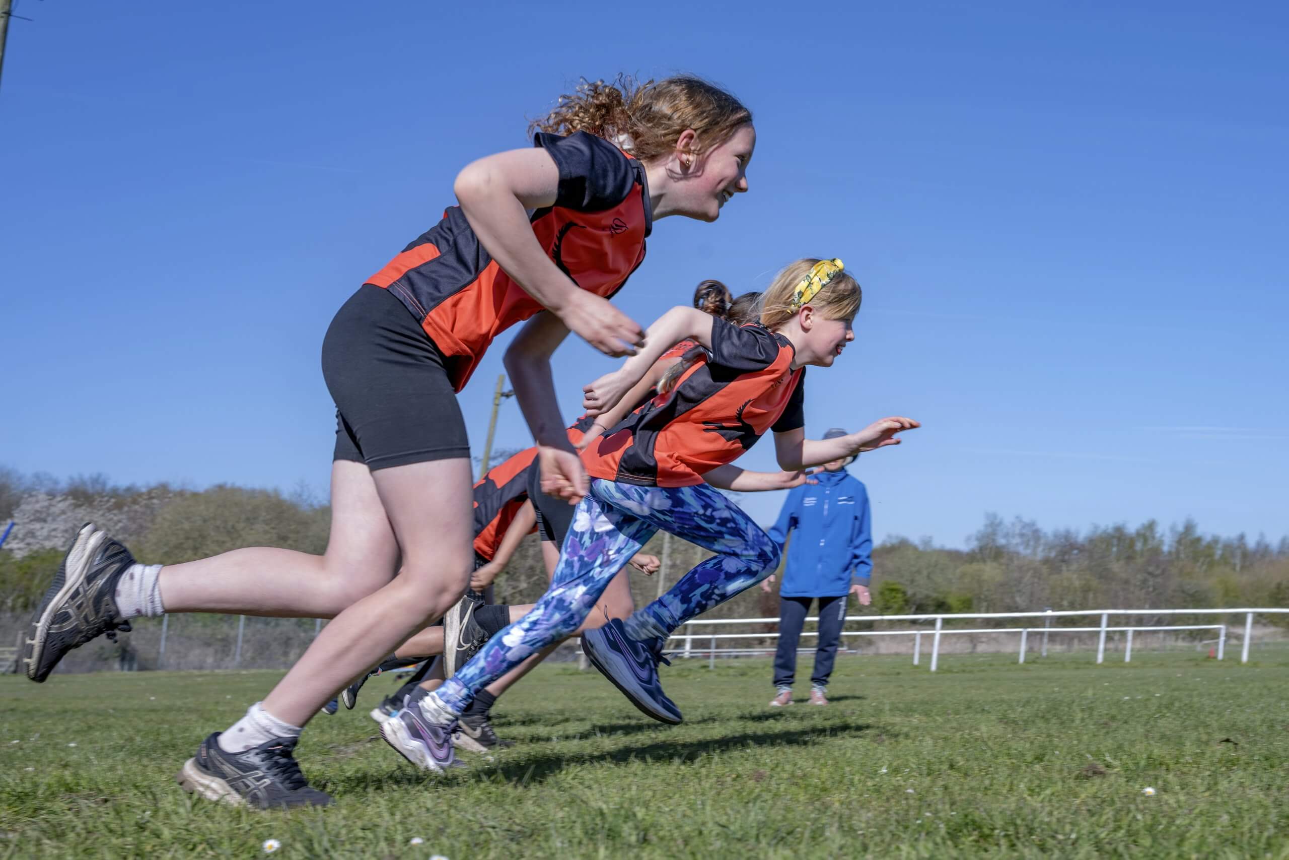 Two girls setting off on a sprint
