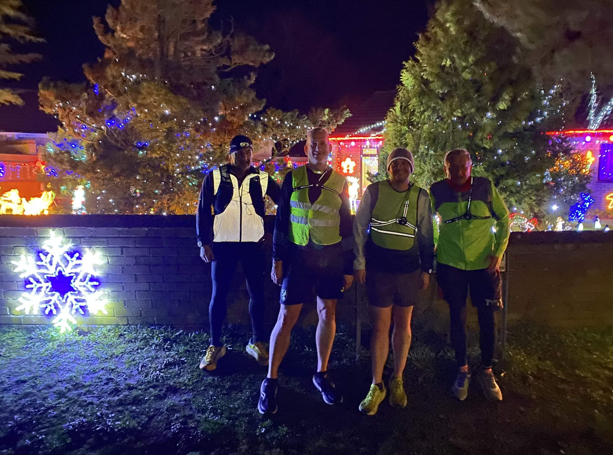 Runners at night in front of festive Christmas lights in Earsham