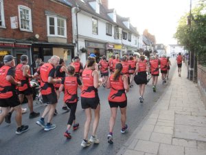 Members of Bungay Black Dog Running Club Running into town as part of the Black Shuck Festival 2025. Taken from behind the runners